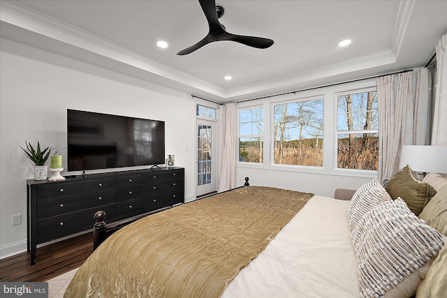 bedroom with recessed lighting, a raised ceiling, crown molding, and wood finished floors