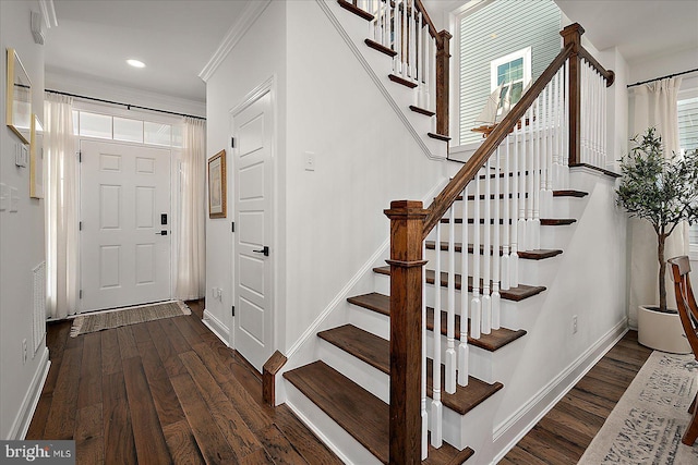 entryway with baseboards, ornamental molding, wood finished floors, and recessed lighting