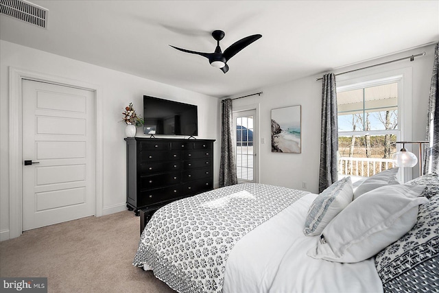 bedroom featuring multiple windows, carpet, visible vents, and access to exterior