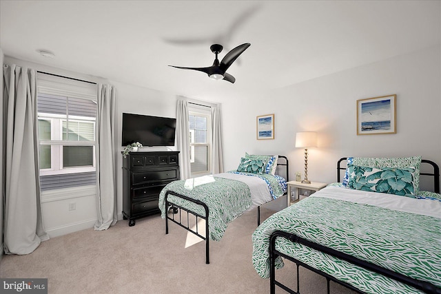 carpeted bedroom with a ceiling fan and baseboards