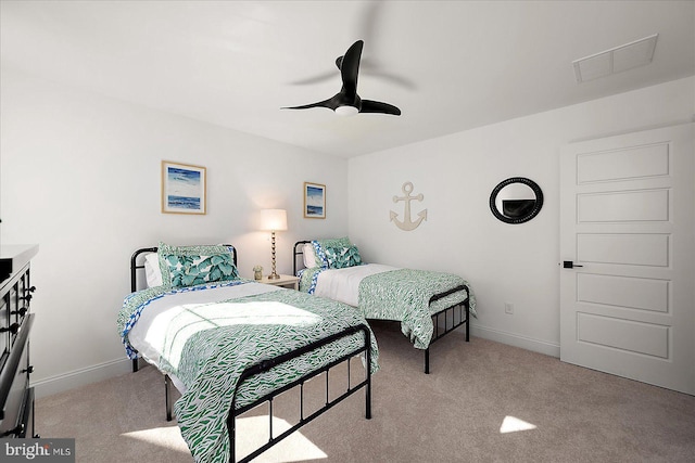 carpeted bedroom featuring ceiling fan, visible vents, and baseboards