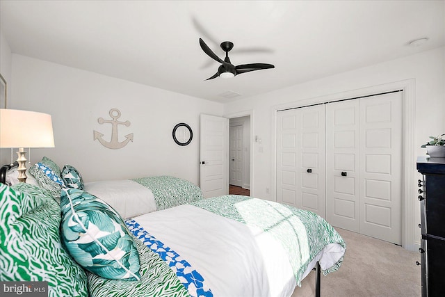 bedroom with carpet floors, a closet, and a ceiling fan