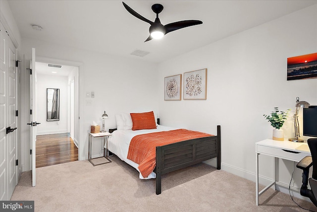 bedroom featuring carpet floors, visible vents, ceiling fan, and baseboards