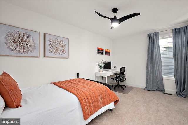 carpeted bedroom with visible vents, baseboards, and ceiling fan