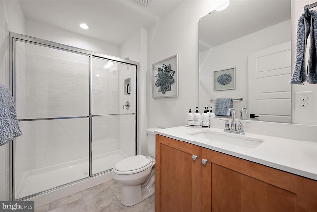 bathroom with vanity, a shower stall, toilet, and recessed lighting