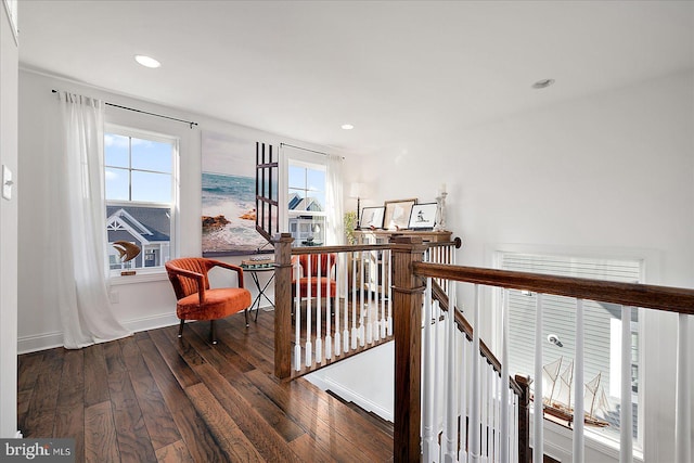 hall with recessed lighting, baseboards, hardwood / wood-style floors, and an upstairs landing