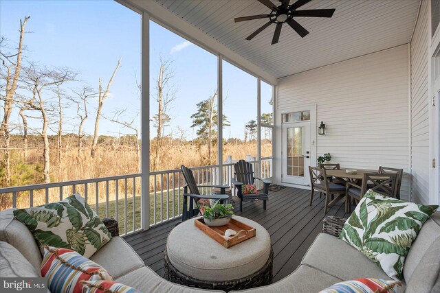 sunroom / solarium featuring a ceiling fan