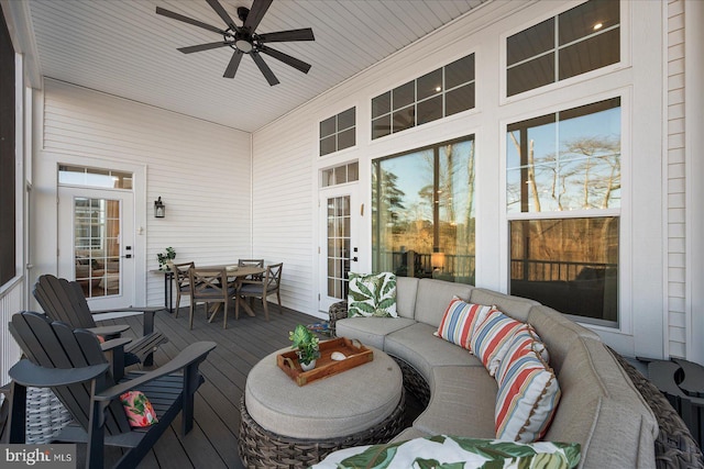 wooden terrace featuring outdoor lounge area, outdoor dining area, and a ceiling fan