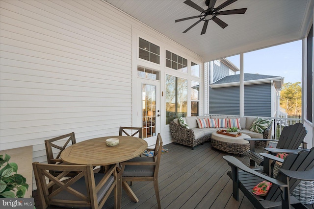 sunroom featuring wood ceiling and a ceiling fan