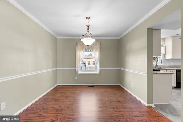 unfurnished dining area with crown molding, wood-type flooring, and sink