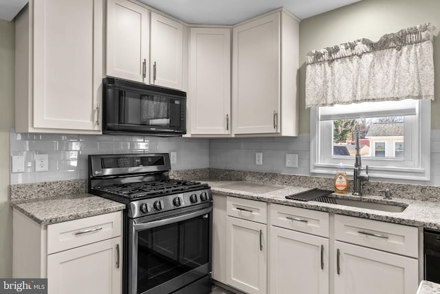 kitchen featuring sink, white cabinetry, backsplash, light stone counters, and black appliances