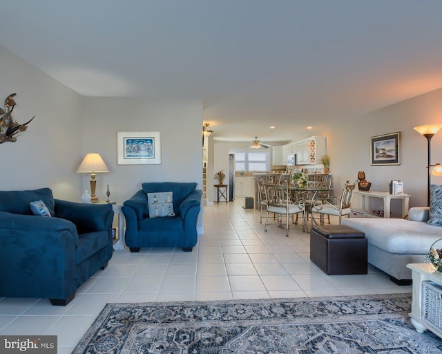 tiled living room featuring ceiling fan