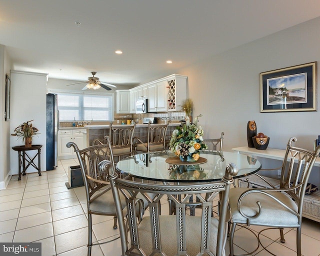 tiled dining room featuring ceiling fan