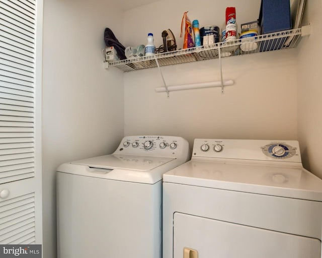 laundry area with washing machine and clothes dryer