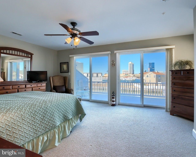 bedroom featuring access to outside, ceiling fan, and carpet