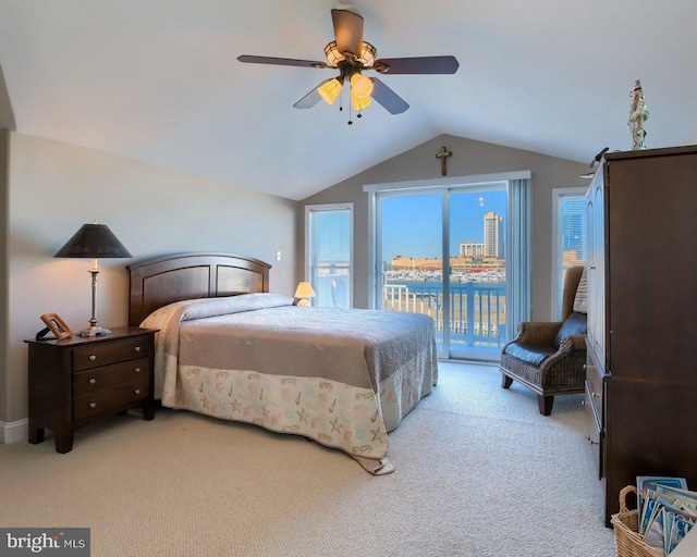 bedroom featuring ceiling fan, lofted ceiling, access to outside, light carpet, and a water view