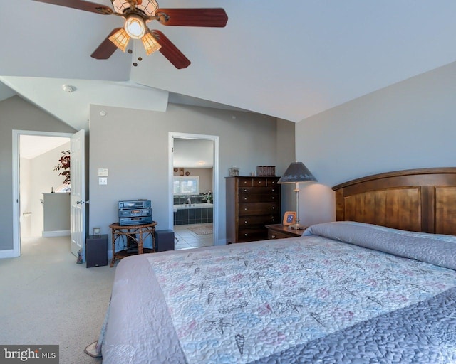 carpeted bedroom with ceiling fan, connected bathroom, and vaulted ceiling