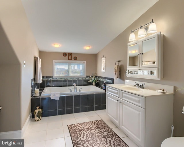 bathroom with tiled tub, tile patterned flooring, and vanity