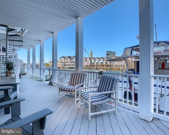 wooden terrace featuring a water view