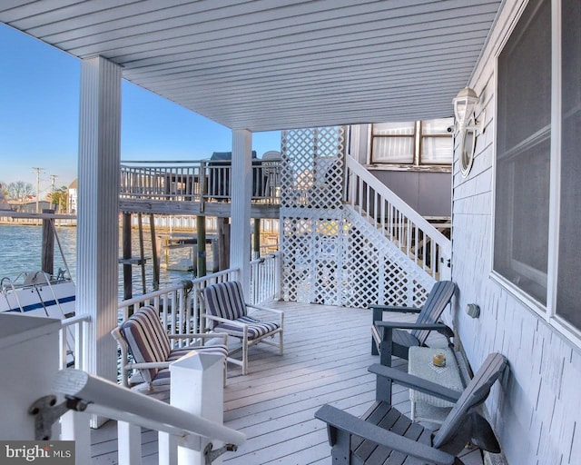 wooden deck featuring a water view