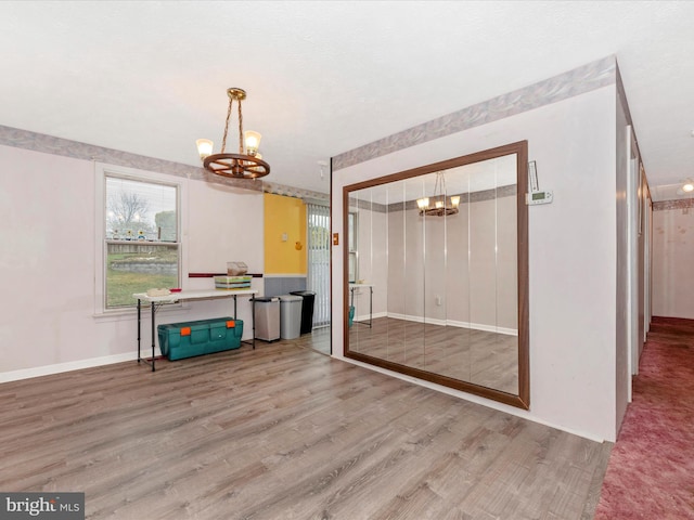 interior space featuring hardwood / wood-style floors and a notable chandelier