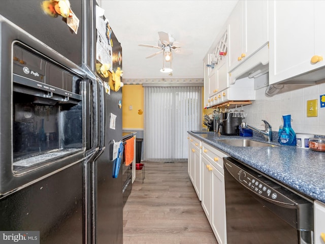 kitchen with black appliances, sink, light wood-type flooring, tasteful backsplash, and white cabinetry