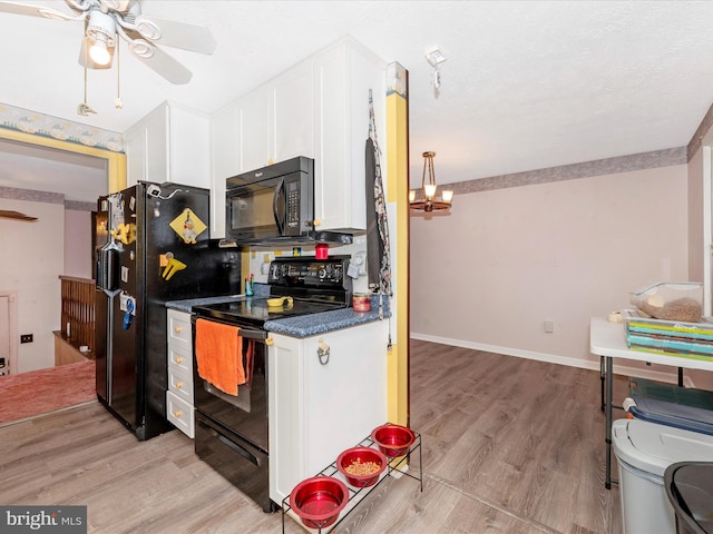 kitchen featuring white cabinets, ceiling fan with notable chandelier, light hardwood / wood-style floors, and black appliances