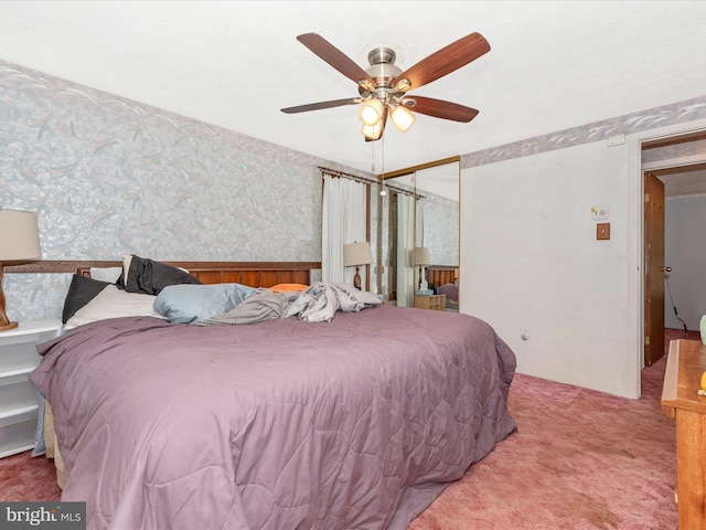 bedroom featuring ceiling fan, a closet, and carpet