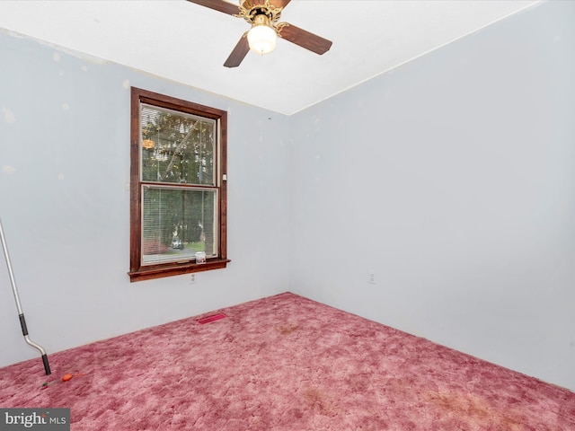 carpeted empty room featuring ceiling fan