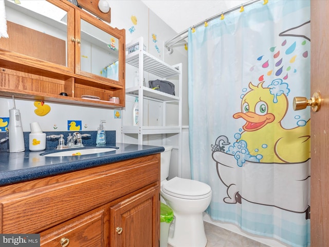 bathroom featuring tile patterned flooring, a shower with curtain, vanity, and toilet