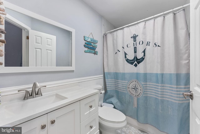 bathroom featuring tile patterned flooring, vanity, and toilet