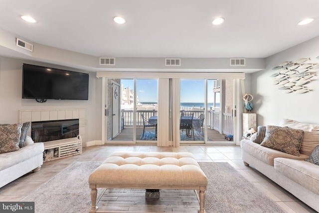 tiled living room featuring a fireplace