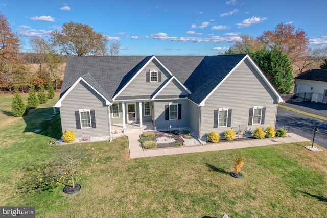 view of front facade with a front lawn and covered porch