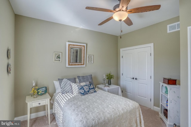 carpeted bedroom with ceiling fan and a closet