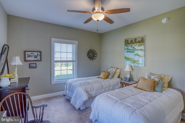 bedroom featuring light carpet and ceiling fan