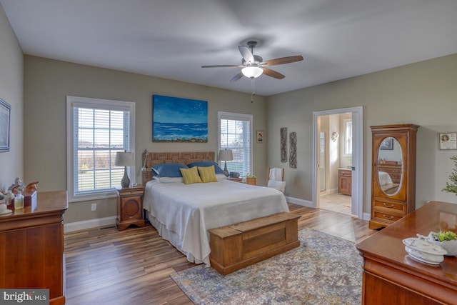 bedroom featuring light wood-type flooring, ensuite bath, and ceiling fan