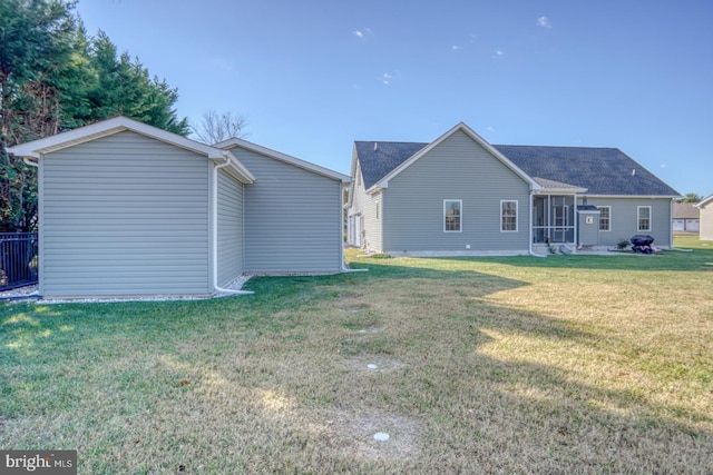 back of property featuring a lawn