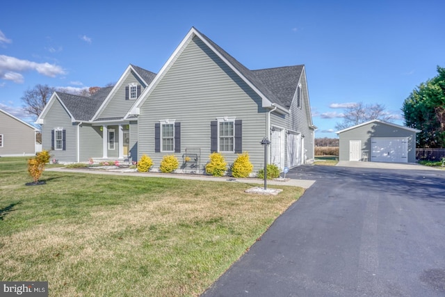 view of front of house featuring an outbuilding and a front yard