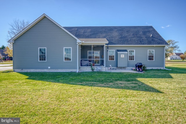 back of house with a sunroom and a yard