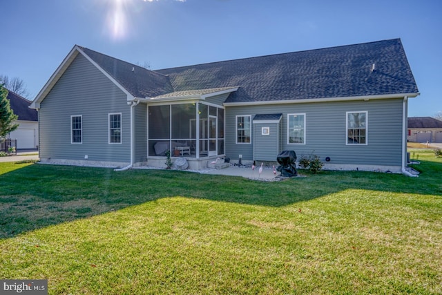 back of house with a lawn, a sunroom, and a patio