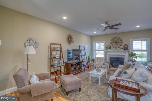 living room with hardwood / wood-style floors, ceiling fan, and plenty of natural light