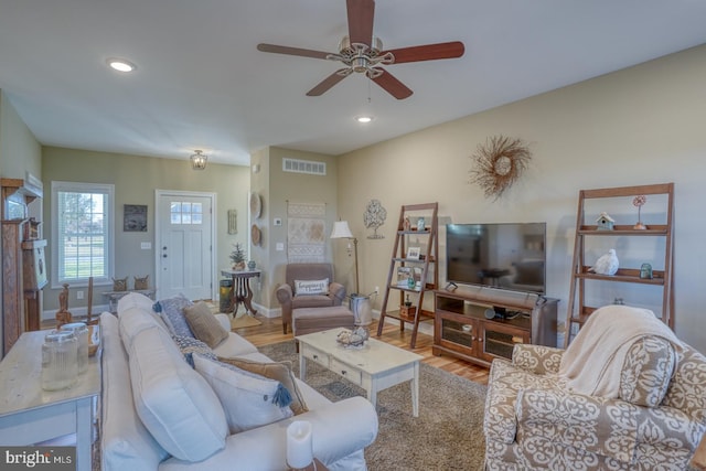 living room with hardwood / wood-style floors and ceiling fan