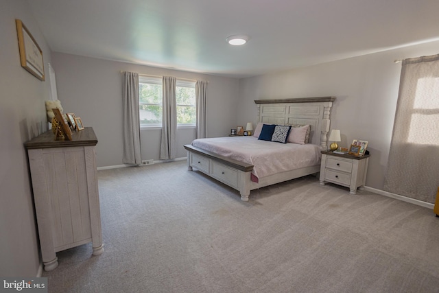 bedroom featuring light colored carpet