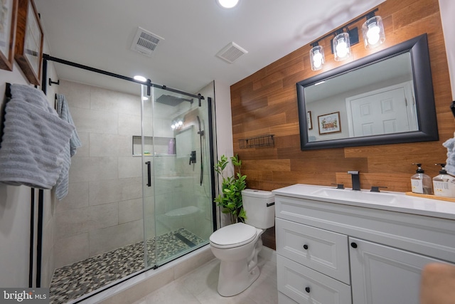 bathroom featuring vanity, wooden walls, toilet, and a shower with door