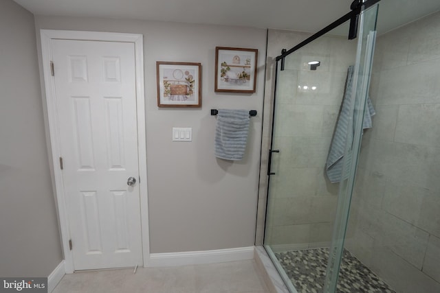 bathroom featuring tile patterned floors and a shower with door