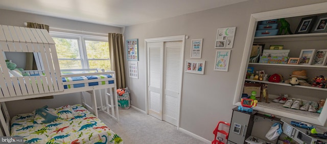 bedroom with light colored carpet and a closet