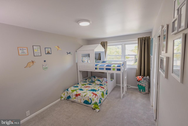 carpeted bedroom featuring multiple windows