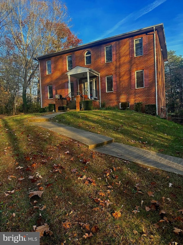 colonial house with central AC and a front lawn