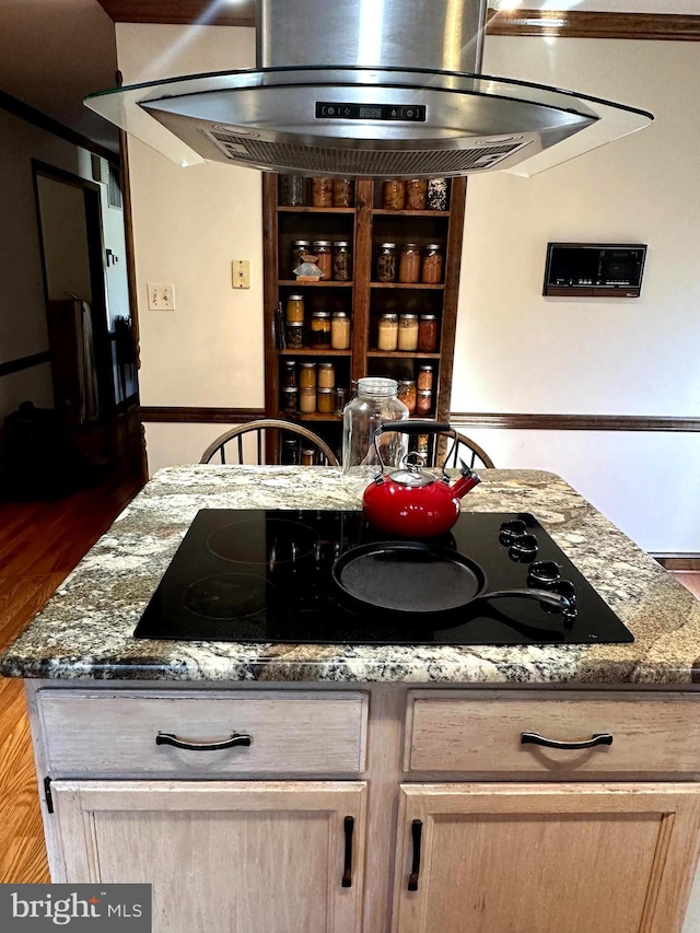 kitchen featuring dark hardwood / wood-style floors, light brown cabinets, black electric cooktop, and exhaust hood