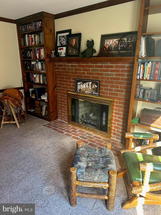 sitting room with crown molding, a fireplace, and carpet floors